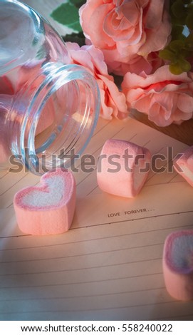 Artificial roses, brown paper and pink marshmallows
