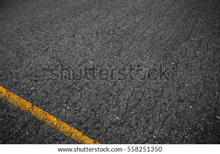 Asphalt background texture with some fine grain with Yellow Stripe