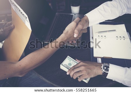 Man offering batch of hundred dollar bills. Hands close up. Venality, bribe, corruption concept. Hand giving money - United States Dollars (or USD). Hand receiving money from businessman.
