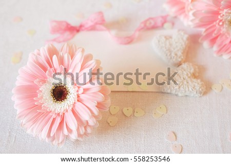 Valentine's Day symbols tender pink gerbera flowers and heart shaped coconut candies