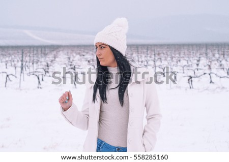 Beautiful young girl posing in the winter 