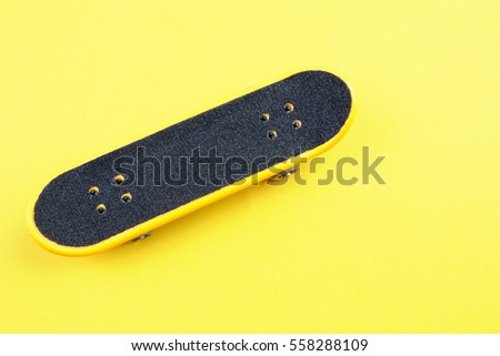 Mini Skate Board Toy in Yellow background.
