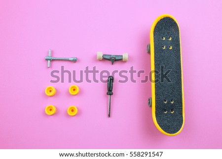 Mini Skate Board Toy in Pink background.