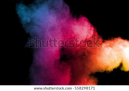 Abstract art colored powder on black background. Frozen abstract movement of dust explosion multiple colors on black background. Stop the movement of multicolored powder on dark background. Royalty-Free Stock Photo #558298171