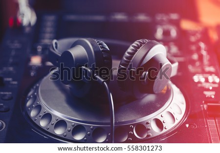 DJ headphone on turn table. Disc jockey headphones on a cd player. Professional disk jokey audio equipment