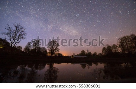 Night view of starry sky near small river.