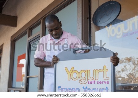 Man opening frozen yogurt store