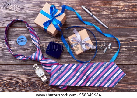 Tie and watch for father. Greeting card and pen. Classic accessories as gift.