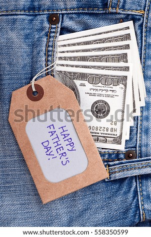 Father's Day tag and dollars. Greeting label on jeans pocket. Pleasant present for dad.