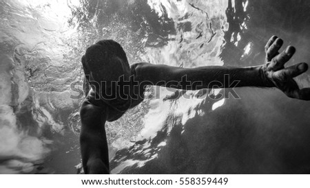 Caucasian man swimming underwater