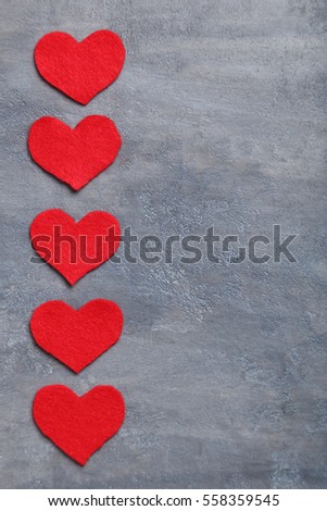 Red hearts on a grey table