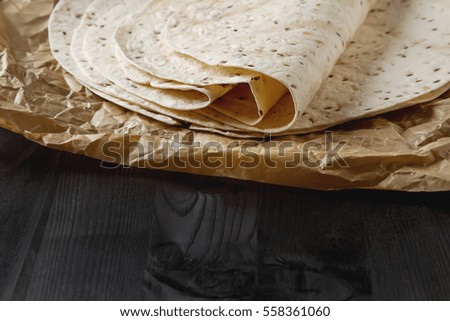 tortilla sheets on gray background. Brown cloth. Mexican food.