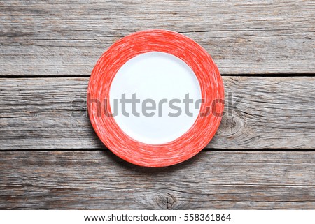 Empty plate on grey wooden table