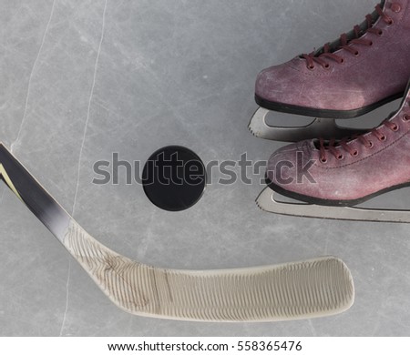 hockey stick, skates and the puck on the ice