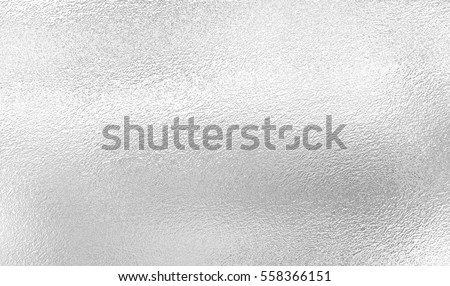 Silver background from metal foil on cardboard decorative texture Royalty-Free Stock Photo #558366151