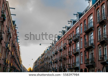 Street with typical amsterdam houses on both sides in winter