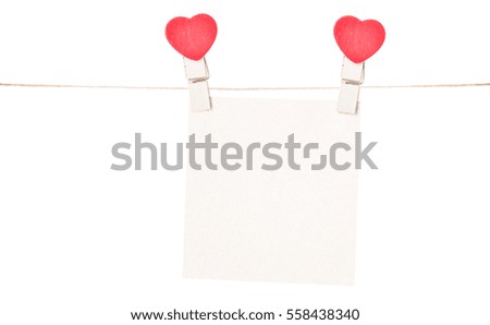 one pieces of blank paper held on a string with heart clothespins isolated on white background.
