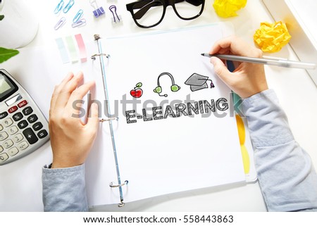 Person drawing E-learning concept on white paper in the office