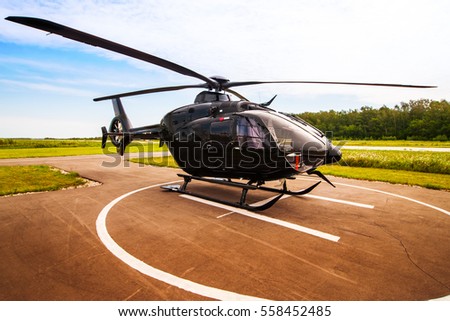 Black helicopter on the helipad Royalty-Free Stock Photo #558452485