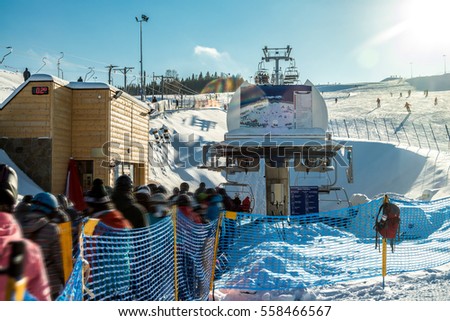 Queue to ski chairlift - winter ski season - winter holidays Royalty-Free Stock Photo #558466567