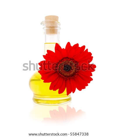 Jug with vegetable oil with a red gerberas