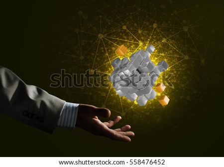 Close of businessman hand holding cube figure as symbol of innovation. 3D rendering