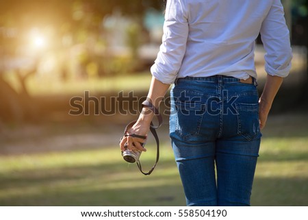 Women holding camera in the nature