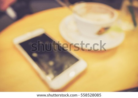 Picture blurred  for background abstract and can be illustration to article of Phone and coffee in cafe