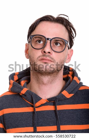 Face of young man wearing eyeglasses while thinking isolated against white background