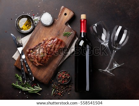 Grilled ribeye beef steak with red wine, herbs and spices. Top view