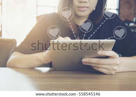 women wear black shirt play tablet at coffee shop : picture idea for valentine day or love concept.