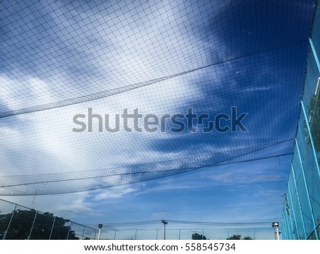 Mesh fence of the football field with blue sky