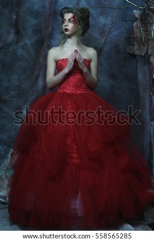 Fashion portrait of romantic beautiful girl with hairstyle, red lips, art dress.Princess in mistery house. Creative concept Once upon a time in fantasy.