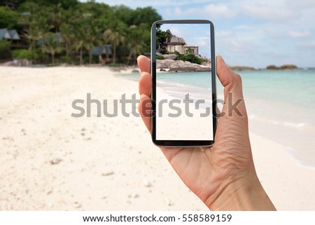 using smart phone take a photo (selfie) on the beach