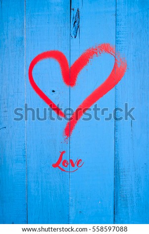 love expression with a heart on blue wooden background