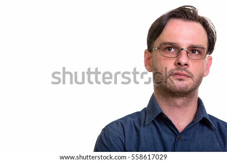 Studio shot of formal young man thinking isolated against white background