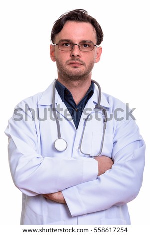 Close up of young man doctor with arms crossed isolated against white background