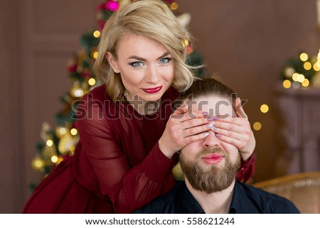 christmas couple, happy young female surprise man cover his eyes