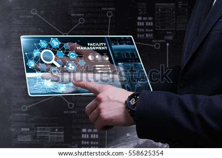 Business, Technology, Internet and network concept. Young business man writing word: facility management  Royalty-Free Stock Photo #558625354