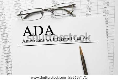 Paper with Americans with Disabilities Act ADA on a table Royalty-Free Stock Photo #558637471