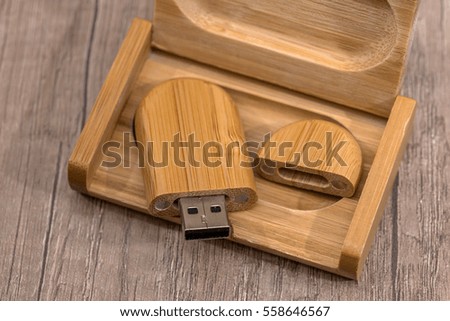 Wooden flash drive on wooden table.