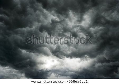 Before heavy rain storm. On the sky is covered all over by the clouds. A lot of lightning and strong wind. The dark clouds is look like  a big  black smoke from  erupting volcano Royalty-Free Stock Photo #558656821