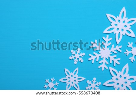 Snowflakes and stars on a blue wooden background