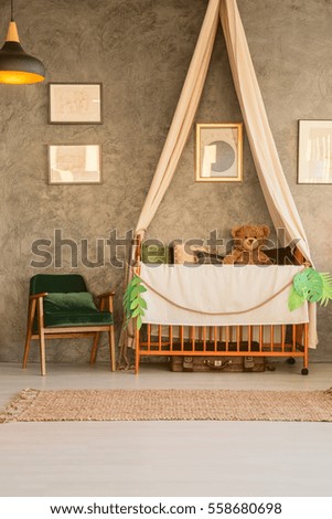 Baby cot with teddy bear in flat apartment