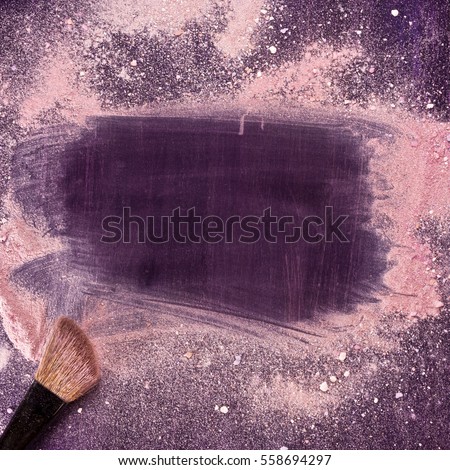 A makeup brush on a purple background, with traces of powder and blush on it forming a frame. A square template for a makeup school business card or flyer design, with plenty of copyspace