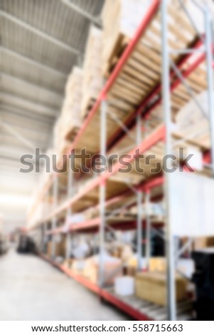 Warehouse of Commerce and Industry of transportation. Boxes and crates stocked on the shelves of three storey. Deep blur effect.