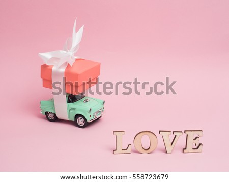 Vanlentine's day concept. Wooden letters word love and red heart  car vintage on wood background with copy space.