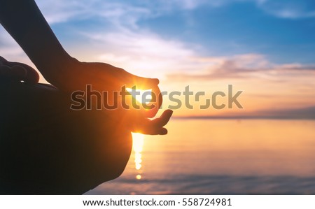 serenity and yoga practicing at sunset,meditation Royalty-Free Stock Photo #558724981