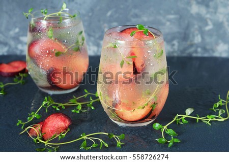 A cocktail of Prosecco with plums and thyme