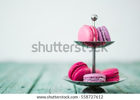 French cake macaroon on a wooden background. Colorful dessert